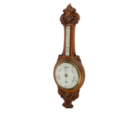 1920s aneroid barometer in a carved oak case.