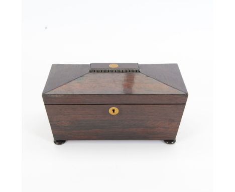 19th century rosewood sarcophagus shaped tea caddy, the hinged lid with brass cartouche to the centre, opening to reveal a fi