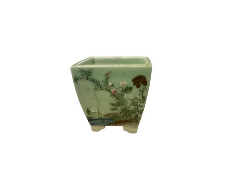 Plant pot decorated with flowering sprigs upon a green ground, H13cm