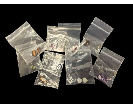 Twenty-three gemstones, various cuts and sizes, including tiger's eye, amethyst, smoky quartx, opal, garnet, etc
