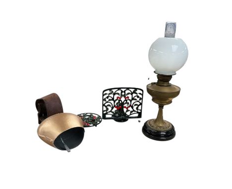 Brass oil lamp, together with cow bell and cast iron book stand and mat