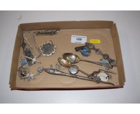 A tray containing various silver and white metal items to include an ingot, spoons, a button hook etc. 