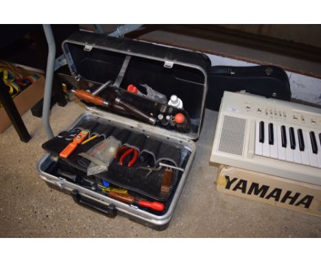 A case of various tools and a violin case 