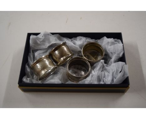 A set of four silver serviette rings with engine turned decoration 