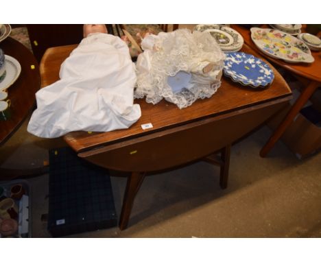 An Ercol drop leaf kitchen table with a set of four chairs 