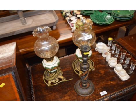 A pair of pottery and brass table lamps with glass shades; and a candlestick 