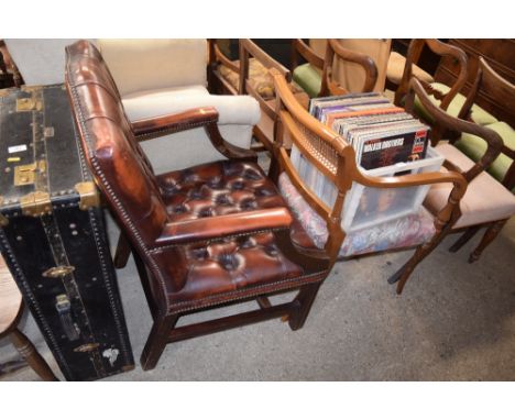 A red leather button down desk chair; and a mahogany and cane backed carver chair 