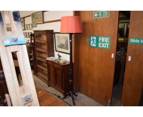 A craved mahogany standard lamp and shade 