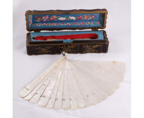 A 19th Century Chinese Mother of Pearl Brisé Fan, with 19 sticks and two guards carved with scenes of daily life with figures