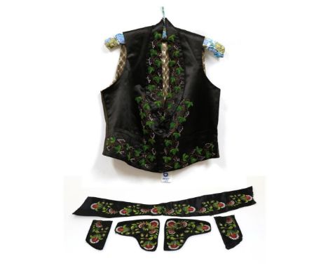 Early 19th Century Black Silk Waistcoat, embroidered with vine and leaves; Five Mid 18th Century Waistcoat Pieces, on black s