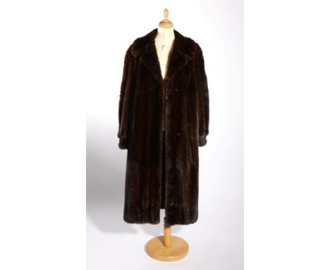 Dark Mink Fur Coat, with cuffed sleeves, side pockets, floral woven lining, and a modern Mannequin (2)Good condition. 44'' bu