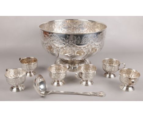 A large Viners of Sheffield silver plated punch set with hand chased floral decoration. Including bowl, ladle and 6 cups.  