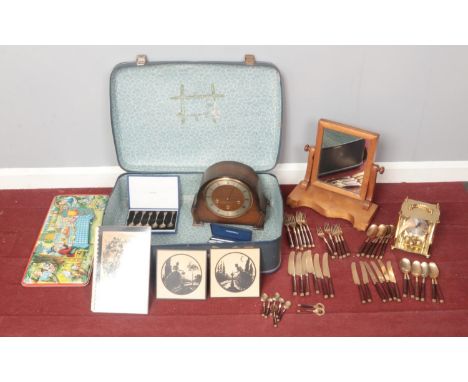 A vintage suitcase containing an assortment of collectables. To include a Ritmeester Cigar Band Album, a cased Sheaffer three