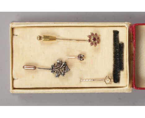 Four stick pins including a 15ct gold example, two yellow metal examples and a silver example.  