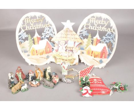 An eleven piece ceramic Christmas nativity scene along with four vintage card Christmas decorations.  