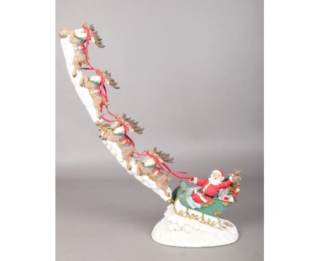 A ceramic Santa's sleigh &amp; reindeers Christmas decoration. 46cm height.  