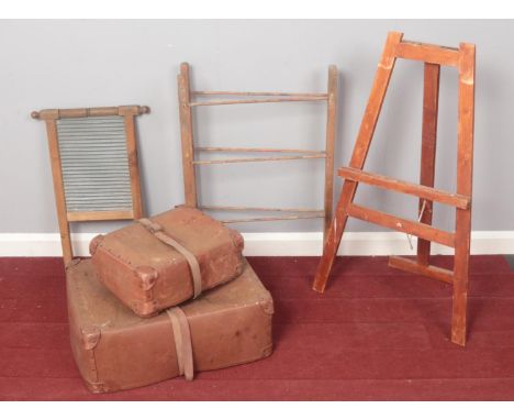 An assortment of miscellaneous. Comprising of two early plastic suitcases, a child's easel, a wooden drying rack and a metal 