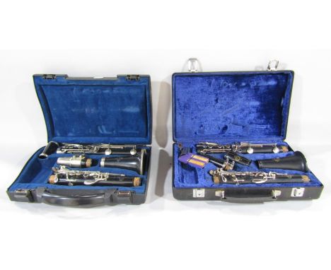 Two Crampon &amp; Cie à Paris Buffet Clarinets one a B10 the other a B12, both in fitted plastic cases and a folding music st