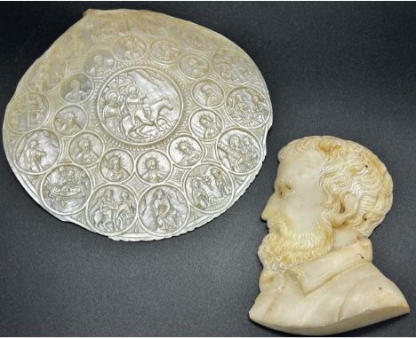 An antique carved Jerusalem, mother of pearl shell with Christian motifs, the central panel, depicting, Christ, riding a donk
