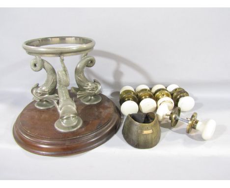 An ice/wine bucket stand, with a removable ring, supported by three flipping dolphins on a circular wooden base, five pairs o