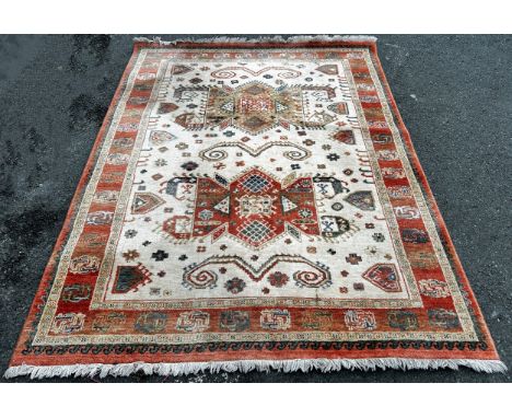 A Kazak type carpet, machine made, with an all over repeating pattern in pale hues on a cream field, 235cm x 170cm. 