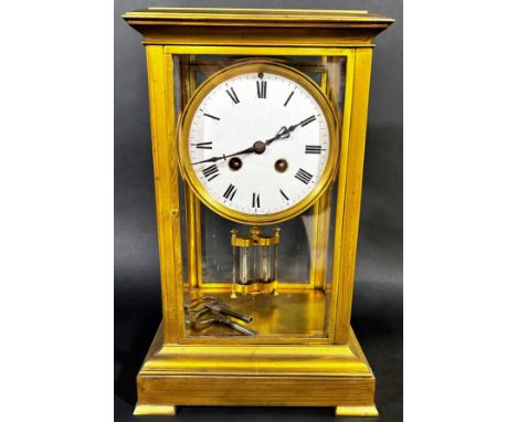 A 19th century four pane brass framed mantle clock with eight day striking movement with mercury compensating pendulum on sho