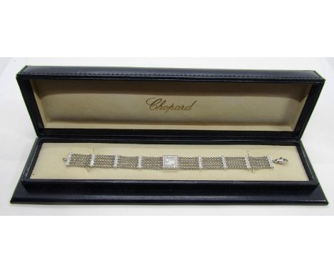 Chopard. An 18ct white gold ‘Happy Diamonds’ bracelet, on a five strand chain bracelet spaced with diamond-set bars, interspe