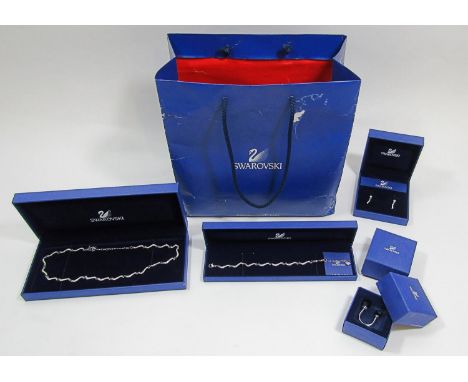 Group of boxed Swarovski jewellery comprising a wavy link necklace, bracelet and earrings suite and a belly ring (4) 