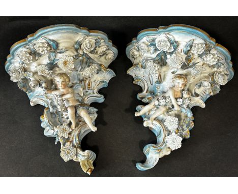 Pair of 19th century porcelain German ceramic brackets, floral encrusted and with cherub supports 