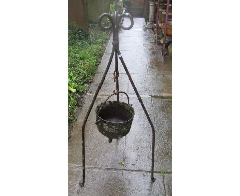 Antique cast iron cauldron with steel loop handle, hung on an ironwork stand (later used as a garden feature/planter) (af) 11