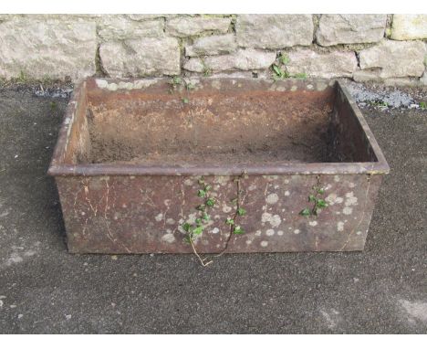 A weathered rectangular iron trough with flared rim, 62cm long x 42cm wide x 21cm high 