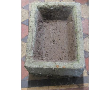 A weathered rectangular natural stone trough with canted interior, 54cm long x 39cm wide x 21cm deep 