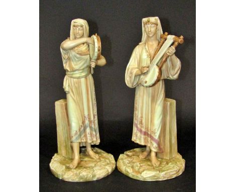 Pair of James Hadley modelled Royal Worcester figures of Egyptian musicians with gilded detail, model 1084 