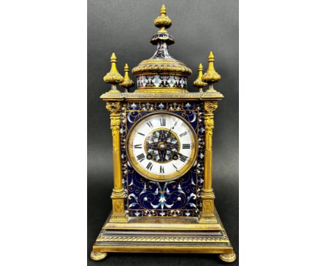 A late 19th century brass and champleve enamel cased mantle clock , with a white enamelled chapter ring and blue ground ename