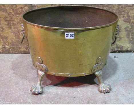 An oval brass coal bin with lions mask and ring handles and splayed paw feet, 42cm x 34cm x 30cm high 