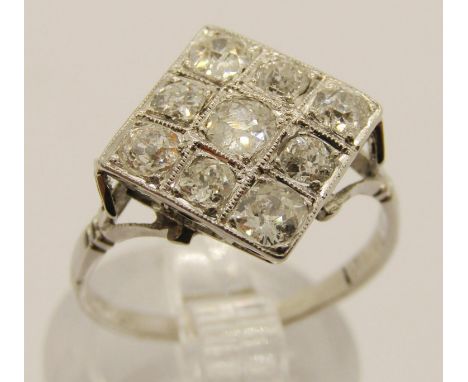 Art Deco white metal diamond cocktail ring, set with nine old-cut diamonds totalling just under 1ct, plaque 10 x 10mm, shank 