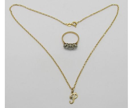 9ct three stone dress ring and a 9ct diamond set 'P' pendant / charm hung from a 9ct chain necklace, 5.3g total 