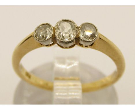 Early 20th century 18ct three stone old-cut diamond ring with millegrain setting, outer pair of diamonds 0.10ct each approx, 