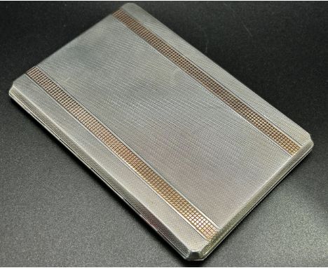 A silver and gold engine turned cigarette case, Birmingham 1949, maker John Rose, 7oz approximately