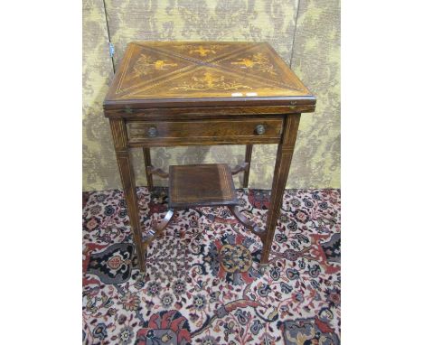 An inlaid Edwardian rosewood envelope card table of usual form on square taper legs with under gallery, with marquetry detail