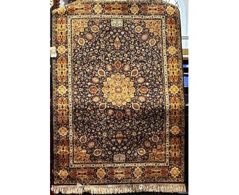 A machine made Persian Wilton type carpet with all over floral design on a dark blue ground, 196cm x 140cm approx.