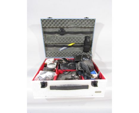 A Rox Metal Hard Case for camera equipment with a padded sponge interior containing a Tamron 75-250mm F/3.8-4.5 zoom lens, a 