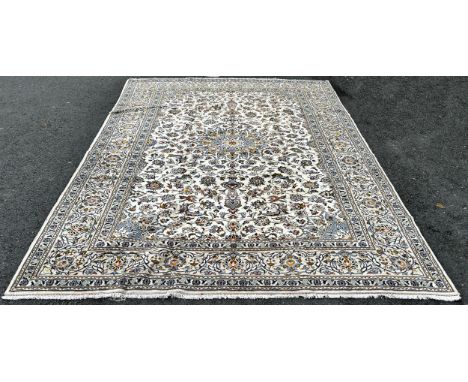 A large central Persian Kashan carpet with an all over floral pattern and floral borders,3.50m  x 2.50m 