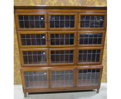 Minty three tier mahogany sectional bookcase, each layer enclosed by three leaded light panelled doors on turned supports, 13
