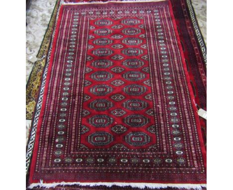 A Bokhara Carpet with alternating row of guls on a predominantly red ground, 180cm x 125cm. 