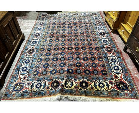 A large Veramin Minakhani carpet with an all over floral pattern on a dark blue ground, 300 x 210 cm approx. 