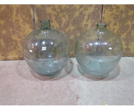 2 similar vintage light green tinted glass carboys, 54cm high 