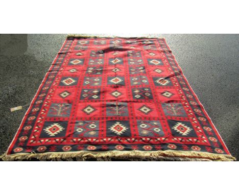 A contemporary reversible Turkish design Kilim type carpet with a bright red and blue square sectioned pattern, to the revers
