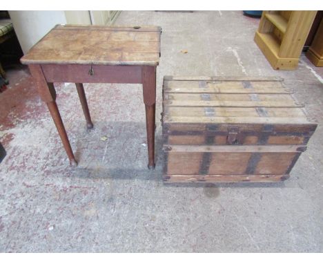 A vintage school desk on pad feet, a further travelling trunk with steel banded borders and a painted cupboard enclosed by tw