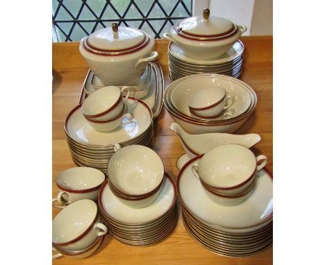 A Langenthal porcelain dinner service with oxblood and gilt banded borders comprising dinner plates, tureens, graduated bowls